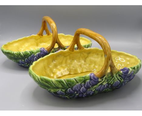 A pair of 'Sarreguemines France' oval pottery baskets, decorated to the exterior with flowers, length 31.5cm.
