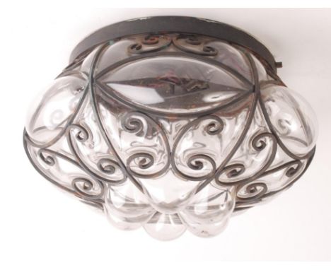 A glass and wrought iron light fitting, diameter 32cm.    Condition report:  Some small areas of rust, glass shade is in good