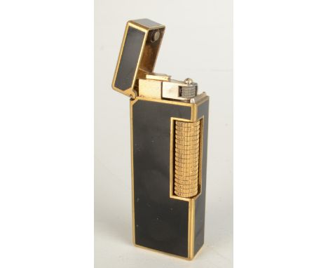 A gold plated and black lacquer Dunhill gas made in Switzerland Rollagas lighter patent 24163 boxed with booklet.
