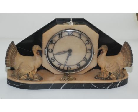An Art Deco marble mantel clock, the 14.3cm dial flanked by a pair of metal turkeys, height 22cm, length 41.5cm.