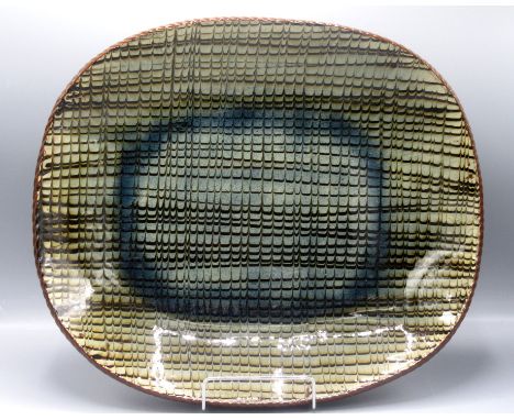 A Margaret Leach slipware pottery dish, with combed decoration, 41.5cm, width 35.5cm. Condition report: No condition issues.