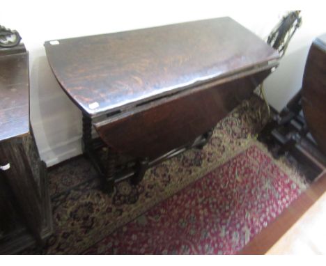 An oak gateleg dining table, 18th century, the oval top above bobbin turned supports joined by rectangular stretchers, height