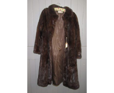 A dark brown, three quarter length mink coat by The Norwich Fur Co., size 10-12.