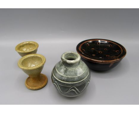 A selection of Winchcombe pottery, comprising a soap dish with pierced cover, two egg cups and a small vase, height 9cm.