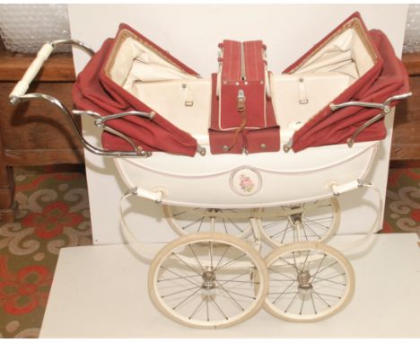 A twin pram in red and white by Silver Cross together with matching shopping bag which can be attached to the pram, to each s