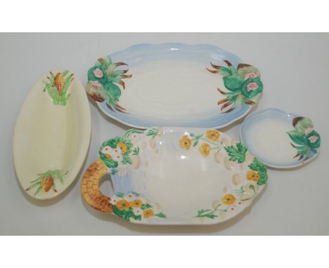 Four miscellaneous Clarice Cliff dishes, largest length 29cm.