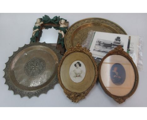 A continental brass charger, 19th century, diameter 44.5cm, a brass tray, diameter 37cm, two oval framed prints in gilt frame