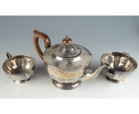 A bats wing fluted silver teapot, a similar twin handled silver sugar bowl and an Art Deco bats wing fluted silver sugar bowl