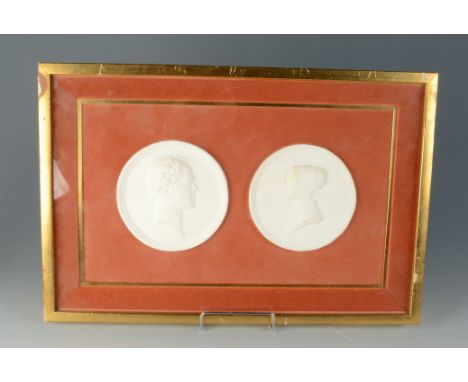 A pair of plaster portrait medallions, in a glazed composition gilt decorated frame, 34.7 x 52cm.