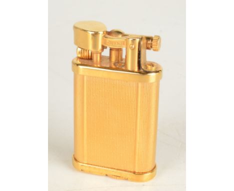 A gold plated Dunhill Unique gas English made lighter serial 396473 boxed maximum height 47mm.