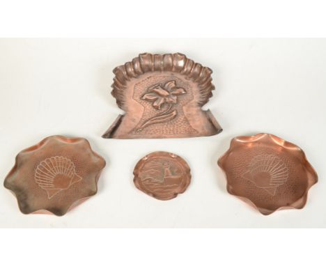 A Herbert Dyer copper tray, embossed with a lighthouse, diameter 11cm, an Art Nouveau copper crumb tray, a circular copper tr
