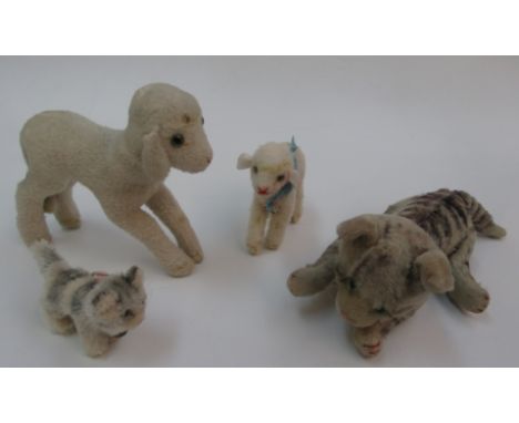 Four plush toys by Steiff, each with button or label.