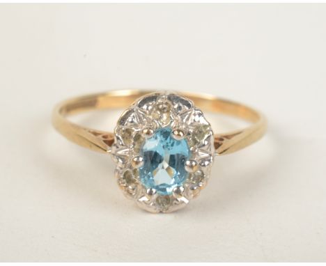 A 9ct gold aquamarine and diamond oval cluster ring. 