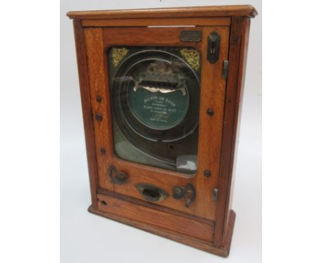 An Allwin de Luxe "Copyright" amusement arcade penny slot machine, with a glazed door and oak case, 70 x 51.5 x 19.3cm. Condi