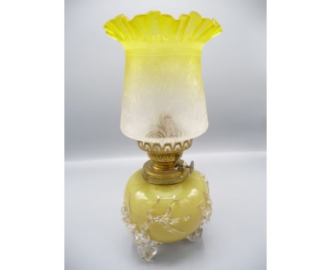 A yellow glass oil lamp and shade, height 29.5cm.