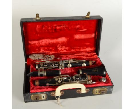A Boosey & Hawkes Regent Clarinet, in a red velvet lined case, length of case 35cm.