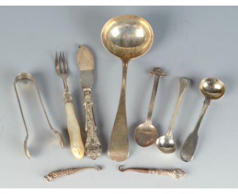 An Arts and Crafts spoon by The Goldsmiths & Silversmith Co. Ltd, a Victorian Old English pattern sauce ladle, a condiment sp