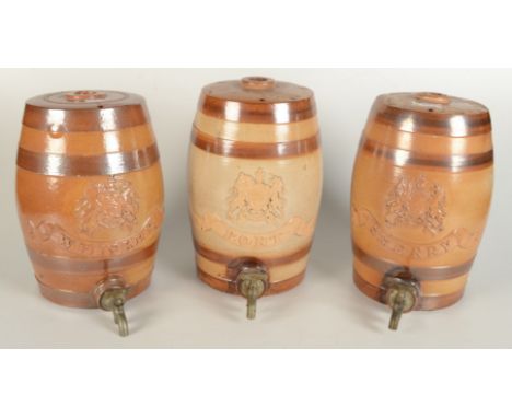 Three stoneware spirit barrels, Port, Sherry and Whiskey, each applied with a Royal Coat of Arms, height 28cm.