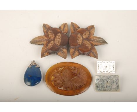 A lapis pendant, a horn buckle, a Chinese carved panel and two Chinese mother of pearl counters mounted as brooches. 