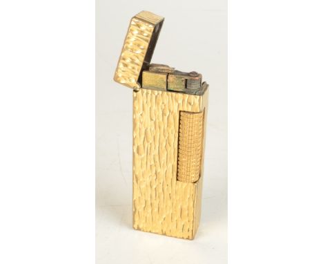 A gold plated textured Dunhill gas made in Switzerland Rollagas lighter patent 24163 boxed with booklet.