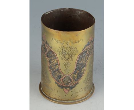A Cairo Ware trench art brass shell case, inscribed to the base R.M.F. 1916, decorated with silver calligraphy, length 11.5cm