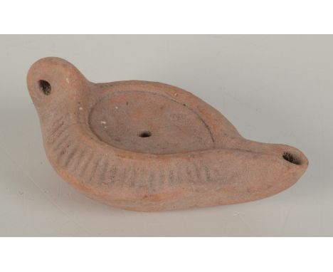 A Roman style terracotta oil lamp, length 15.5cm. 