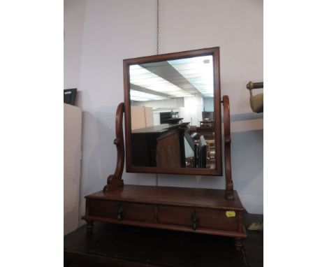 A mahogany serpentine dressing toilet mirror, 19th century, the square bevelled glass above three drawers on bracket feet, he