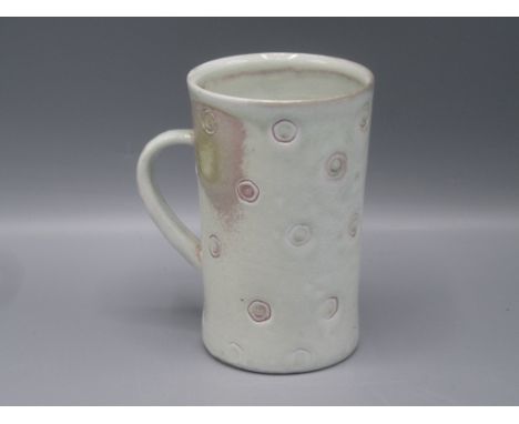 A Jim Malone Studio Pottery mug, the white glaze with incised roundels, height 12cm, diameter 8cm.    Condition report:  All 