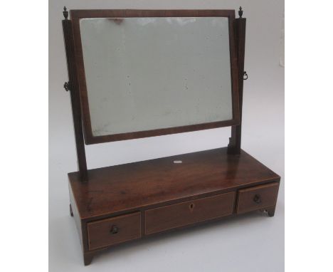 A mahogany dressing table mirror, 19th century, the rectangular plate on reeded supports, above three drawers on bracket feet