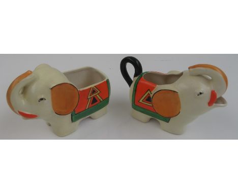 A Japanese pottery Art Deco style cream jug and sugar bowl, in the form of elephants, height 11cm, width 16.5cm.