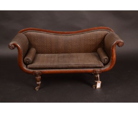 A rare William IV mahogany dolls sofa, the shaped back above a padded seat and arms on turned and fluted tapering supports, h