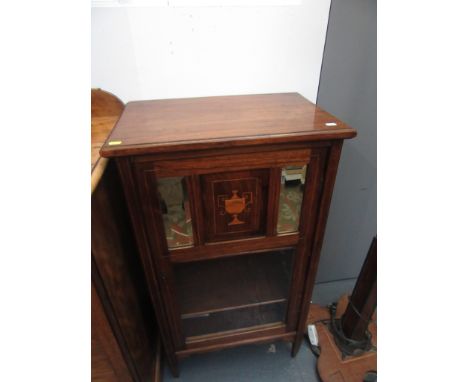 An Edwardian rosewood inlaid music cabinet, the single door with a central inlaid panel decorated with an urn flanked by a pa