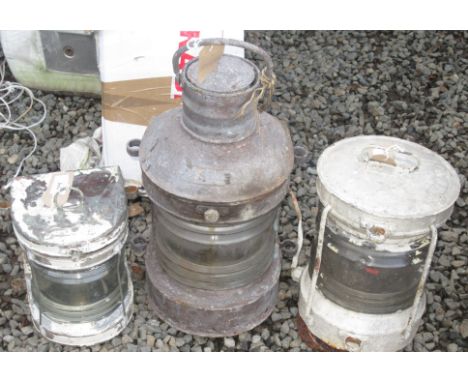 A ship's galvanised 'masthead' lamp, a similar smaller copper lamp and a circular painted 'anchor' lamp.