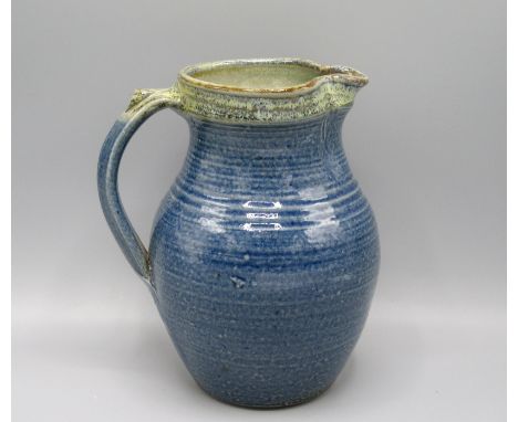A Ray Finch Winchcombe Pottery jug, with a blue mottled ground, height 20cm.  