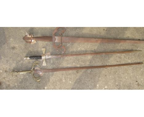 A Wilkinson Sword ceremonial/ritual sword together with two reproduction medieval display swords. 