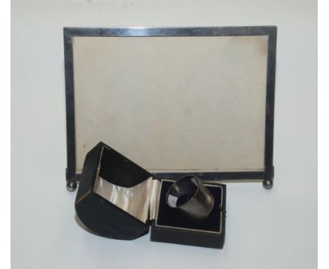 A patent EPNS photograph frame and a silver napkin ring, cased.