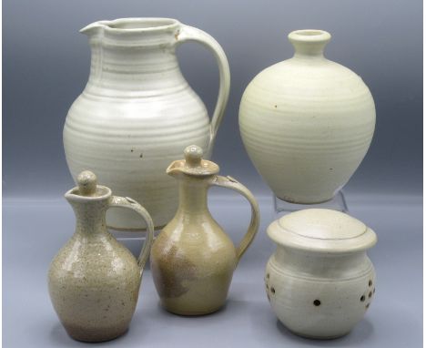 A Winchcombe Pottery cream ground jug, height 21cm and a similar garlic jar, height 9.5cm, a vase, and two oil and vinegar ju