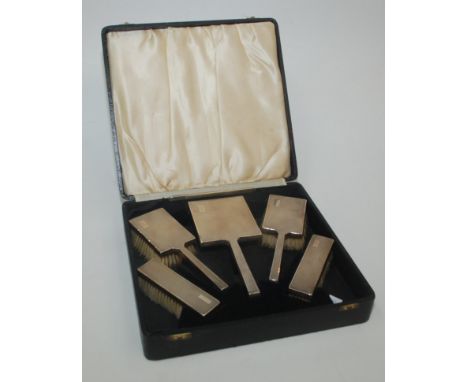 An engine turned six piece silver mounted brush set, Birmingham 1938. 