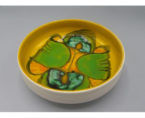 A Poole pottery bowl, the yellow ground with abstract designs, diameter 17.5cm.