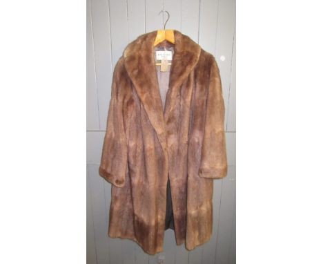 A brown mink three quarter length coat, with silk lining, probably size 14-16.