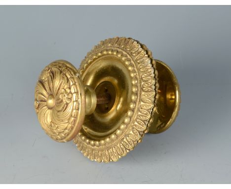 A large heavy brass door handle with acanthus leaf cast plates, the knobs cast with flowers and leaves, together with a cast 