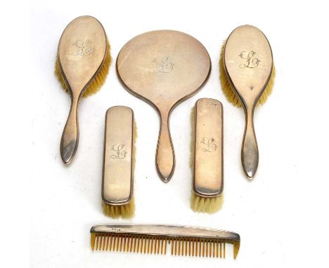 A silver mounted dressing table set, by A&amp;J Zimmerman, Birmingham 1920, comprising hand mirror, two hand brushes, two clo