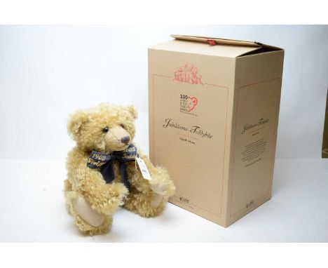 A Steiff Centenary Jubilee blonde teddy bear, with blue ribbon inscribed ‘1902’ and ‘2002’, button and label to ear, in box.