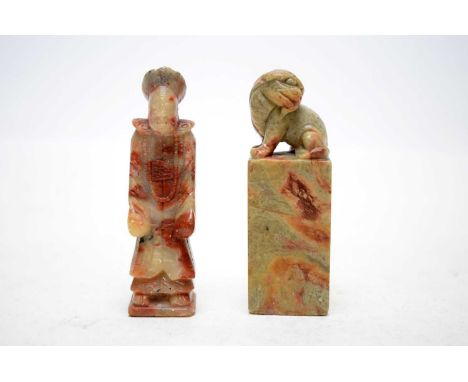 A Chinese carved soapstone table seal, with foo dog finial, 9cms high; together with another Chinese carved soapstone table s