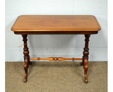 A Victorian mahogany hall table, the rounded rectangular top raised on turned pillar supports over scrolling legs, 91 x 46 x 