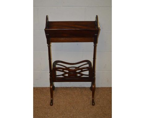 An early 20th Century mahogany bookstand, formed of bookrest with pierced sides, raised on turned pillar supports joined by a