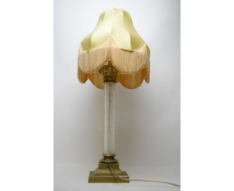 A 20th Century gilt metal table lamp, with cut glass pillar support over a stepped square base, with shade, wired for electri