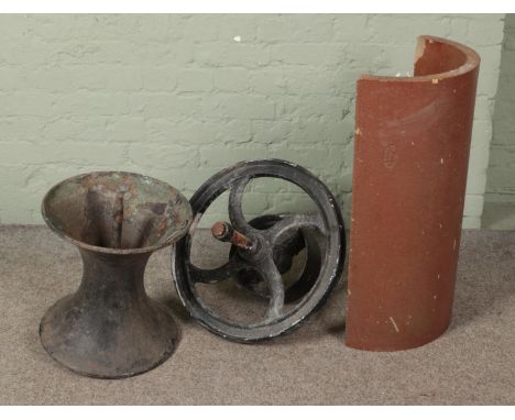A cast iron diablo style pot together with cast iron wheel and half drainage pipe marked J Kitson and Sons Denby Dale.  