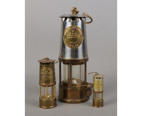 An Eccles Type 6 miners lamp along with two miniature mining lamps inscribed Sir Humphry Davy, 1778-1829.  