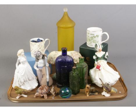 A quantity of ceramics and glass. Includes Royal Doulton figures, Nao, glass poison bottles, lidded vase, two Goebel birds, C